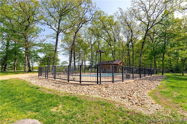 view of swimming pool featuring fence, a fenced in pool, and a lawn