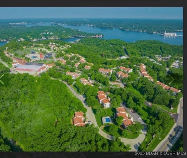 aerial view with a water view and a forest view
