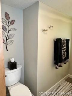 145 Costa Del Sol Dr Unit 2A, Lake Ozark, MO 65049 - bathroom featuring toilet and baseboards