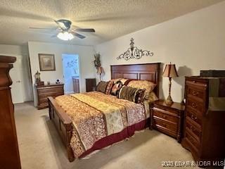 145 Costa Del Sol Dr Unit 2A, Lake Ozark, MO 65049 - carpeted bedroom with a textured ceiling and a ceiling fan