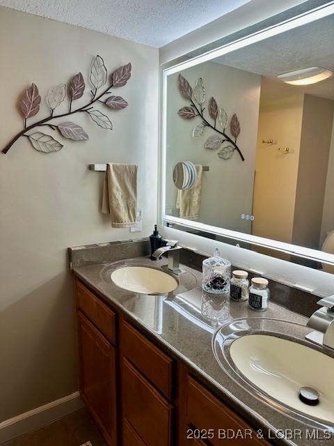 145 Costa Del Sol Dr Unit 2A, Lake Ozark, MO 65049 - bathroom with a textured ceiling and double vanity