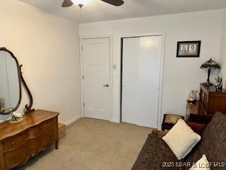 145 Costa Del Sol Dr Unit 2A, Lake Ozark, MO 65049 - living area featuring a ceiling fan and light carpet