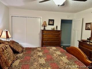 145 Costa Del Sol Dr Unit 2A, Lake Ozark, MO 65049 - carpeted bedroom featuring a closet and a ceiling fan
