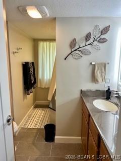 145 Costa Del Sol Dr Unit 2A, Lake Ozark, MO 65049 - bathroom with tile patterned floors, vanity, and baseboards