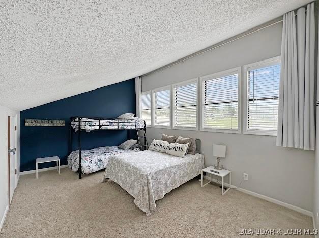 1117 Passover Rd Unit K-8, Osage Beach, MO 65065 - bedroom with a textured ceiling, carpet, and lofted ceiling