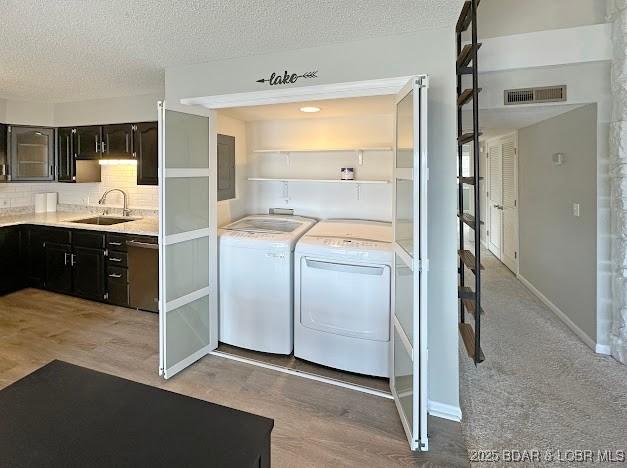 1117 Passover Rd Unit K-8, Osage Beach, MO 65065 - laundry room with separate washer and dryer and a textured ceiling