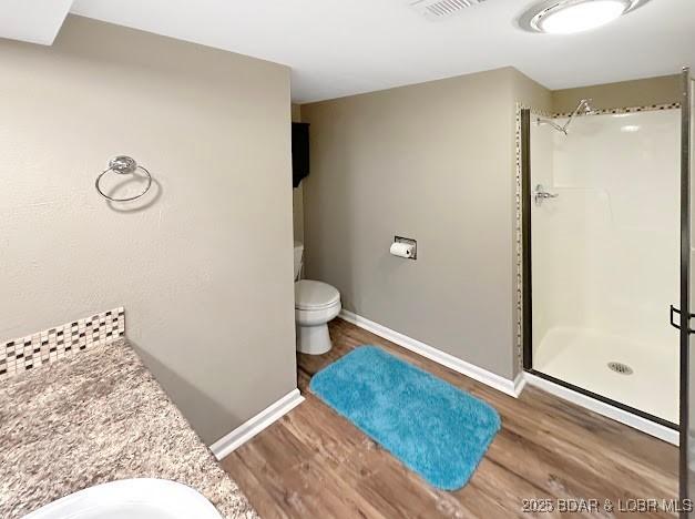 1117 Passover Rd Unit K-8, Osage Beach, MO 65065 - full bathroom featuring wood finished floors, a stall shower, and vanity