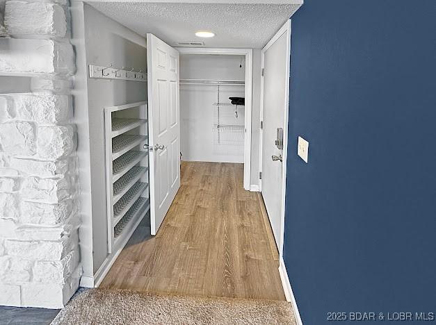 1117 Passover Rd Unit K-8, Osage Beach, MO 65065 - corridor featuring a textured ceiling and wood finished floors