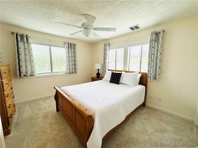 1117 Passover Rd Unit K-8, Osage Beach, MO 65065 - bedroom with multiple windows, light colored carpet, ceiling fan, and a textured ceiling