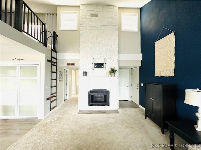 1117 Passover Rd Unit K-8, Osage Beach, MO 65065 - unfurnished living room featuring a towering ceiling and a fireplace
