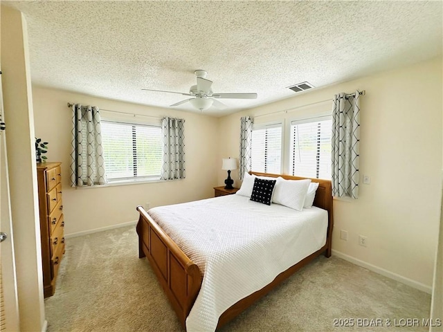 1117 Passover Rd Unit K-8, Osage Beach, MO 65065 - bedroom with multiple windows, light carpet, ceiling fan, and a textured ceiling