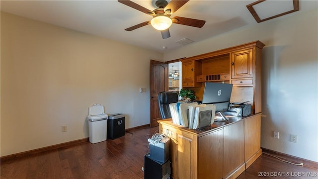 office space with a ceiling fan, baseboards, and dark wood finished floors