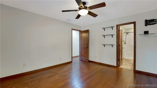 unfurnished bedroom with baseboards, visible vents, ceiling fan, and hardwood / wood-style flooring