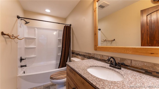 bathroom with shower / tub combo with curtain, vanity, toilet, and visible vents