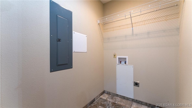 clothes washing area with laundry area, baseboards, hookup for a washing machine, electric panel, and hookup for an electric dryer