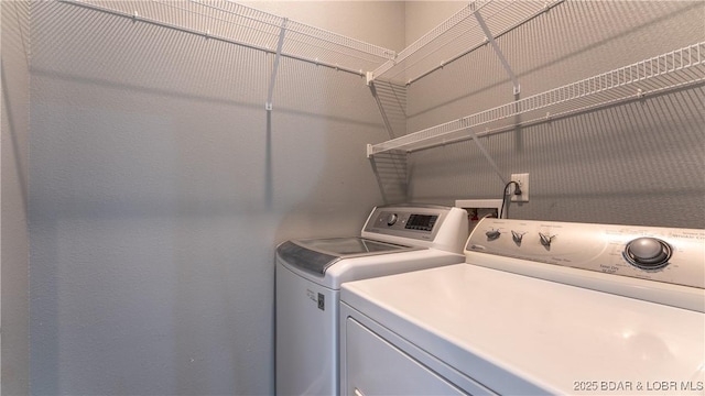 laundry area with laundry area and independent washer and dryer