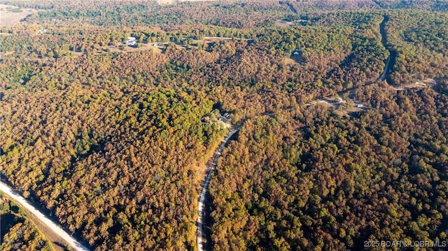 birds eye view of property with a wooded view