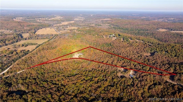 birds eye view of property with a wooded view