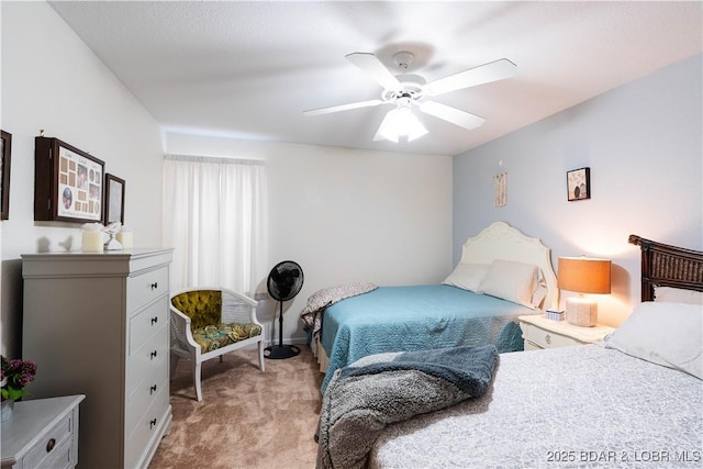 bedroom with a ceiling fan and light carpet