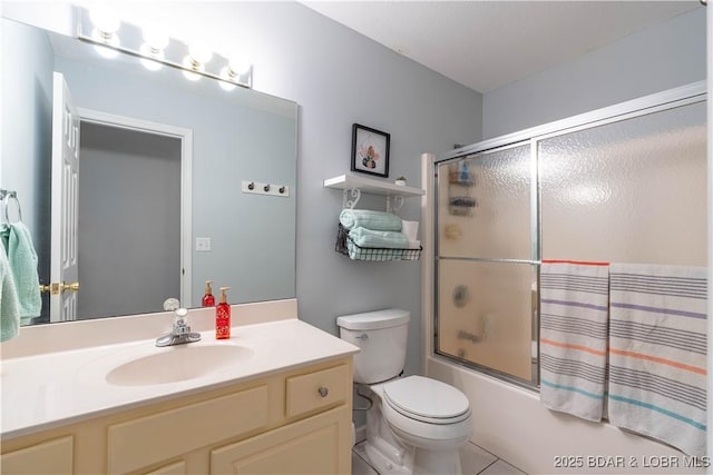 full bath with vanity, bath / shower combo with glass door, and toilet