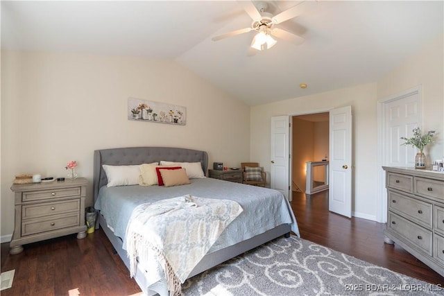 bedroom with baseboards, lofted ceiling, wood finished floors, and ceiling fan