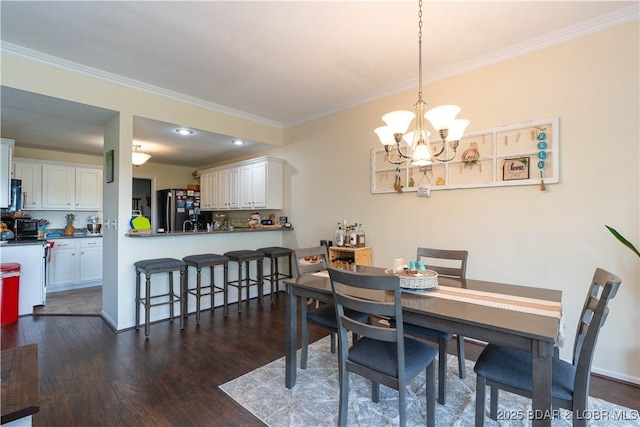dining area featuring crown molding, a notable chandelier, and dark wood-style floors