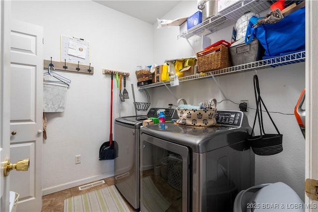 washroom featuring baseboards, laundry area, washing machine and dryer, and visible vents