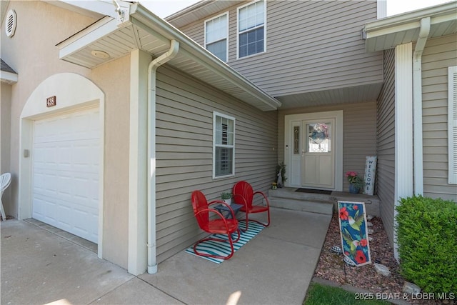 view of exterior entry with an attached garage