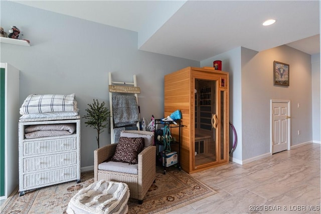 living area featuring baseboards, recessed lighting, and marble finish floor