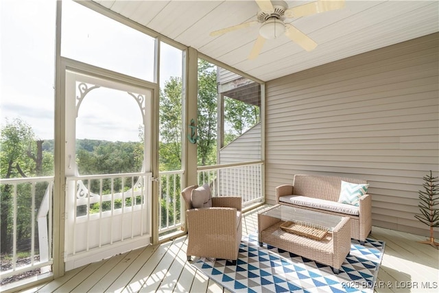 sunroom with plenty of natural light and a ceiling fan