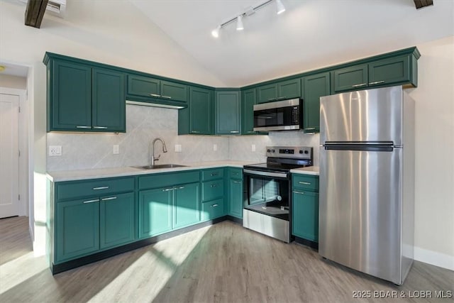 kitchen with track lighting, light wood-style floors, light countertops, a sink, and stainless steel appliances