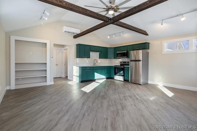 421 W High St, Eldon, MO 65026 - kitchen with green cabinets, stainless steel appliances, rail lighting, an AC wall unit, and lofted ceiling
