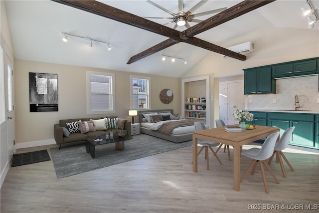 421 W High St, Eldon, MO 65026 - living area featuring track lighting, a wall unit AC, light wood-style flooring, and baseboards