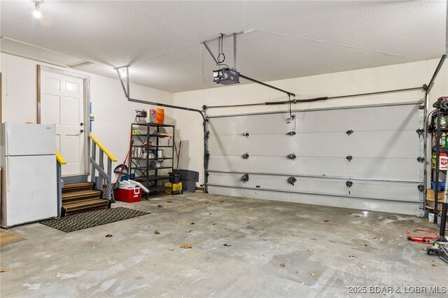20168 Lost Valley Rd, Warsaw, MO 65355 - garage featuring freestanding refrigerator and a garage door opener