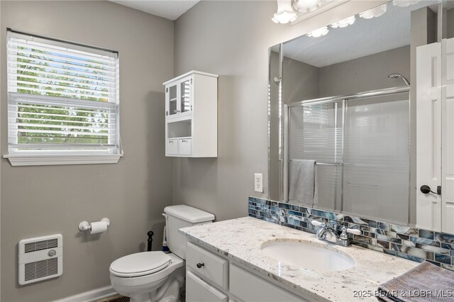 20168 Lost Valley Rd, Warsaw, MO 65355 - full bathroom featuring heating unit, a stall shower, toilet, vanity, and baseboards