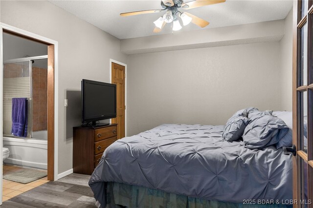 20168 Lost Valley Rd, Warsaw, MO 65355 - tiled bedroom with a ceiling fan and ensuite bath