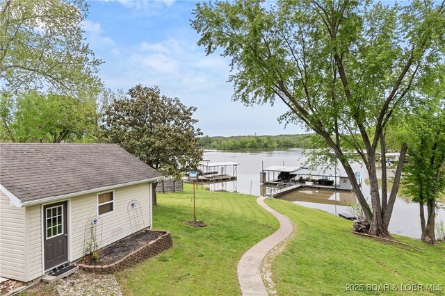 20168 Lost Valley Rd, Warsaw, MO 65355 - view of grassy yard featuring a boat dock, a water view, boat lift, and an outdoor structure