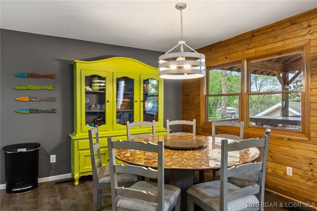 20168 Lost Valley Rd, Warsaw, MO 65355 - dining area with dark wood-type flooring, baseboards, a chandelier, and wooden walls
