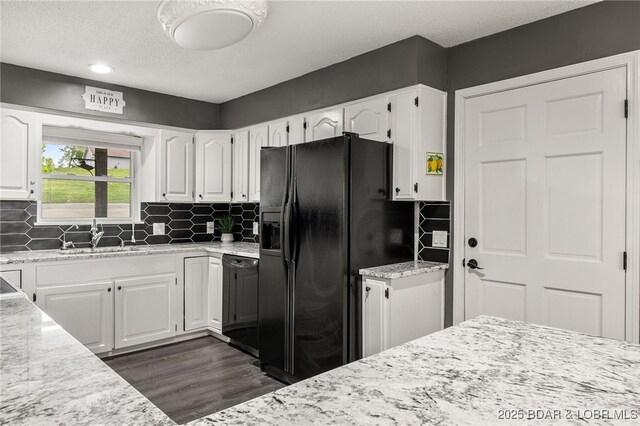 20168 Lost Valley Rd, Warsaw, MO 65355 - kitchen with black appliances, white cabinets, dark wood-style flooring, a sink, and decorative backsplash