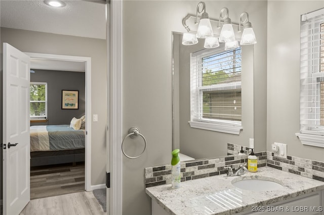 20168 Lost Valley Rd, Warsaw, MO 65355 - ensuite bathroom with plenty of natural light, wood finished floors, vanity, and a chandelier
