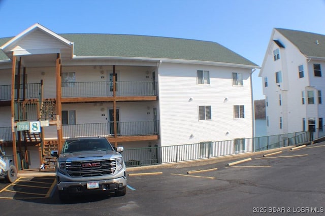 view of building exterior with uncovered parking