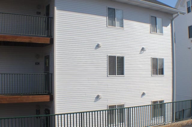 view of side of property with a balcony