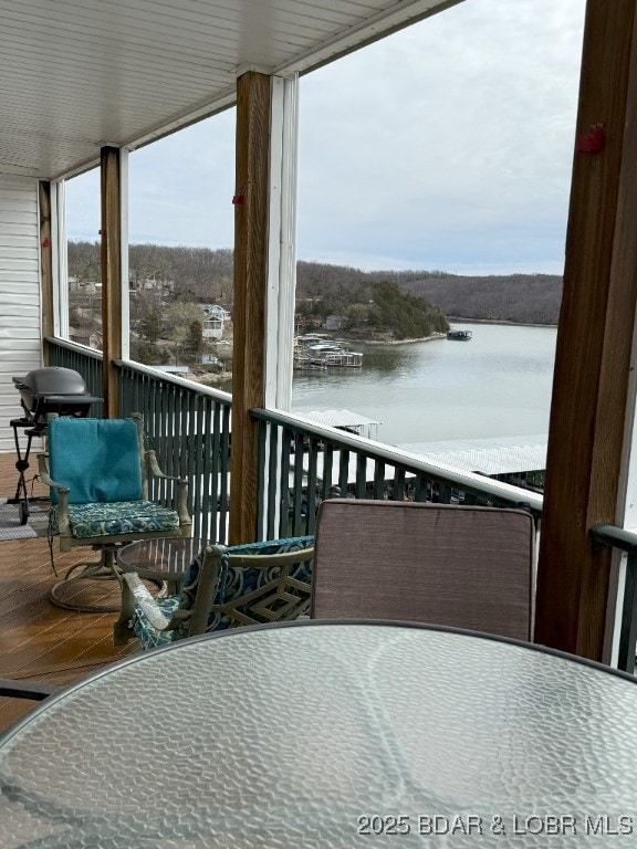 exterior space with a water view and a grill