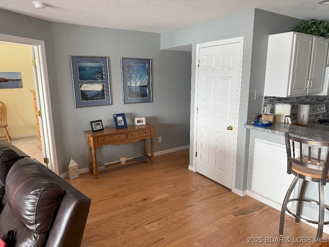 interior space featuring light wood-style floors and baseboards