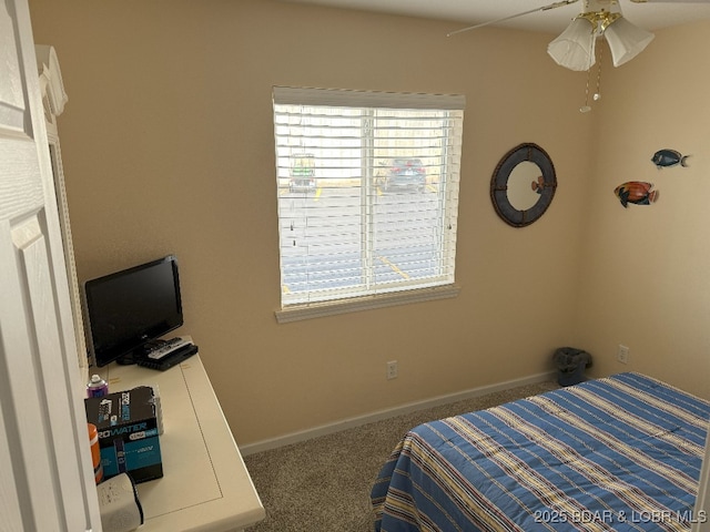 carpeted bedroom featuring baseboards and ceiling fan
