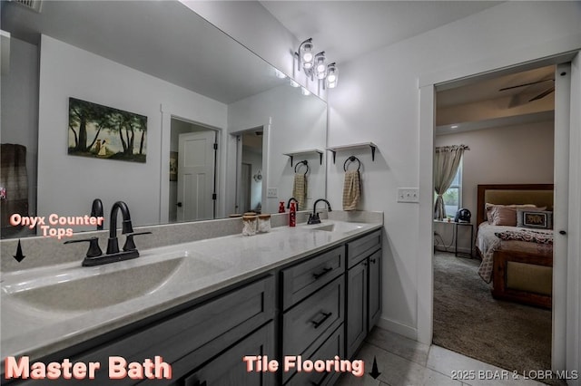bathroom with connected bathroom, double vanity, a sink, and tile patterned flooring