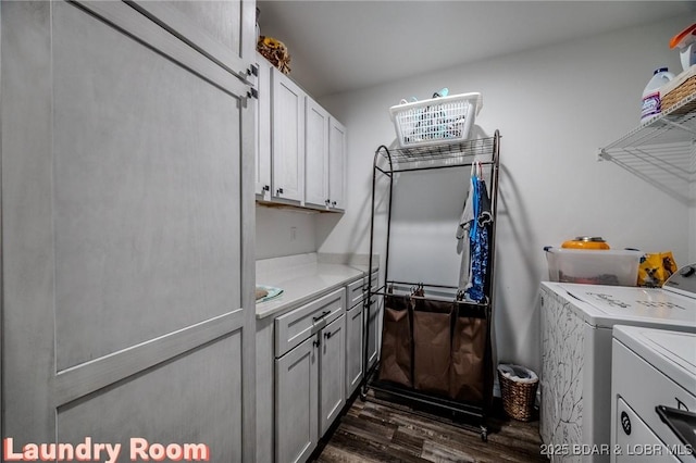 laundry room featuring independent washer and dryer, cabinet space, and dark wood-type flooring