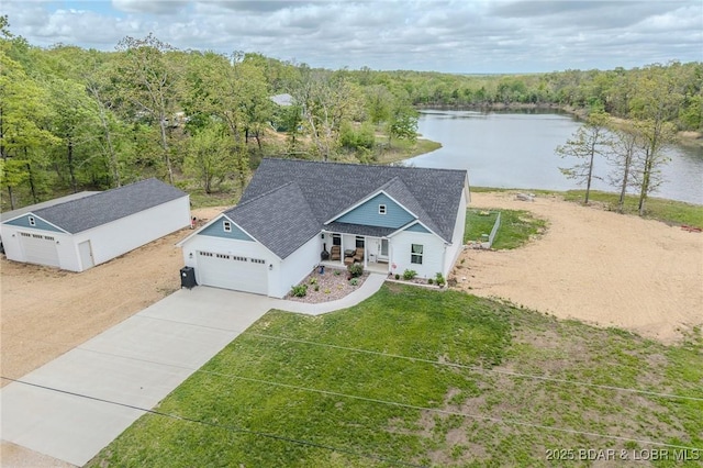 drone / aerial view featuring a water view and a view of trees