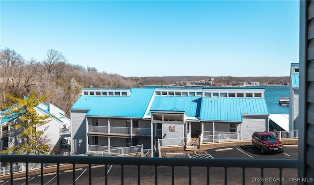 view of front of home featuring a balcony, metal roof, and a standing seam roof