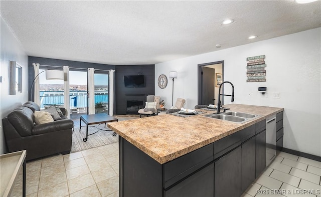 kitchen with a sink, a textured ceiling, and open floor plan